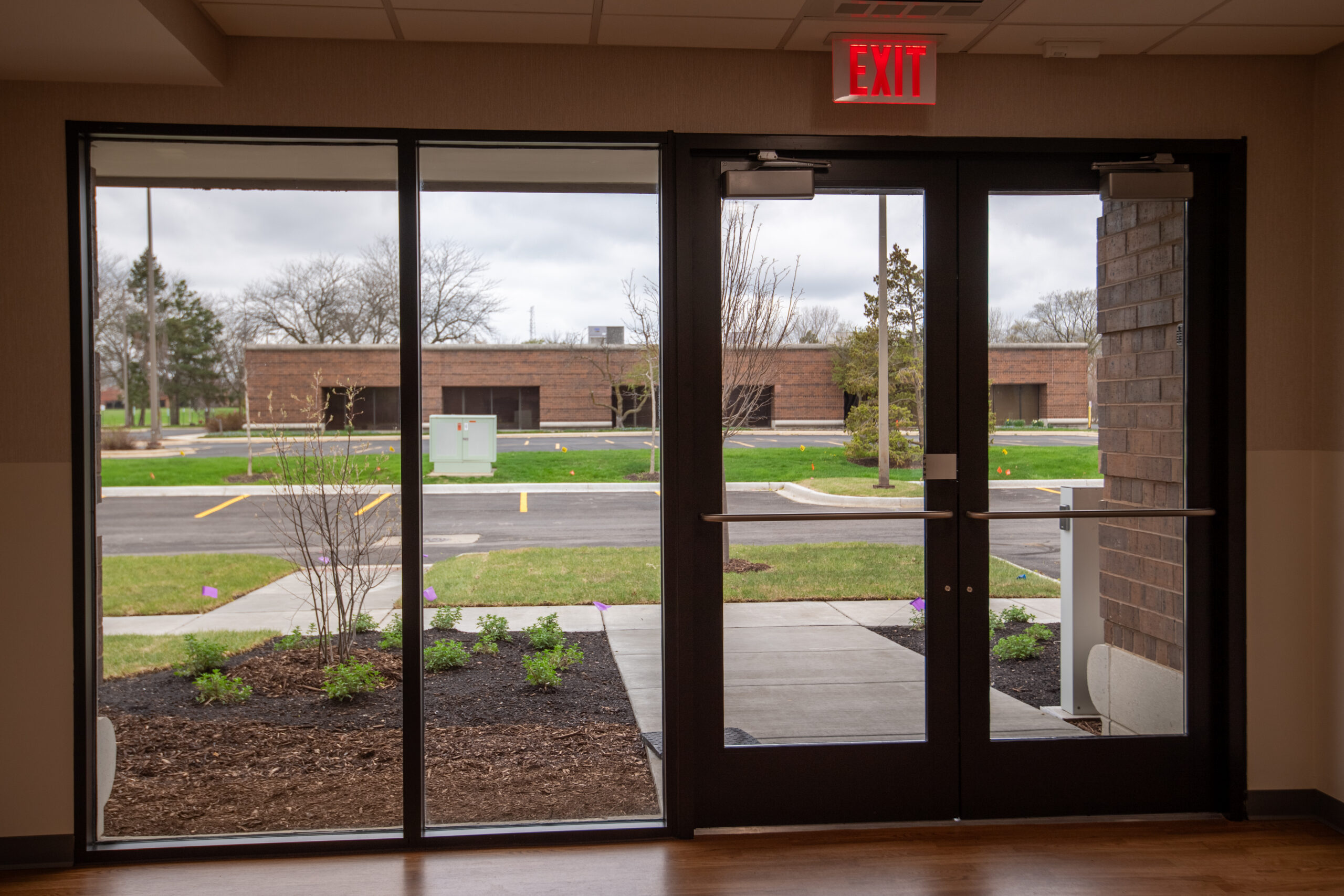 Interior commercial glass entry doors with sidelites and exterior visibility.