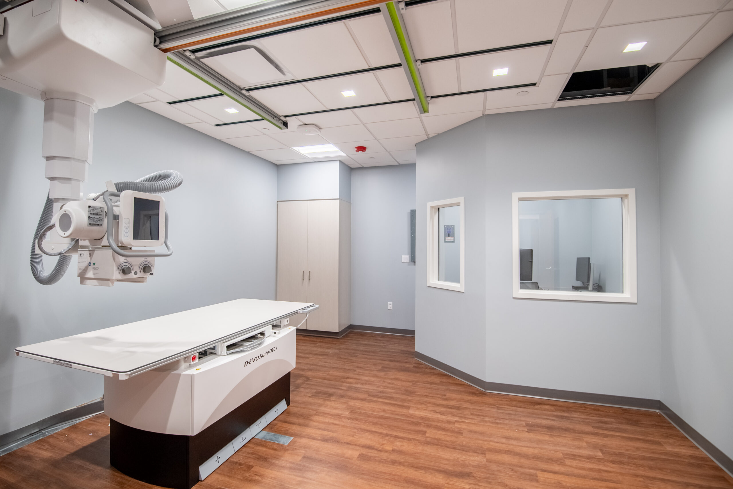 Medical imaging room with equipment, observation windows, and interior glazing.